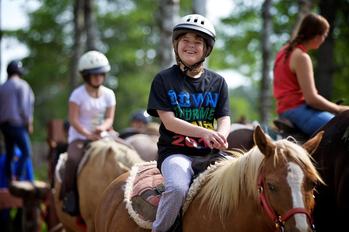 Camper horseback riding.