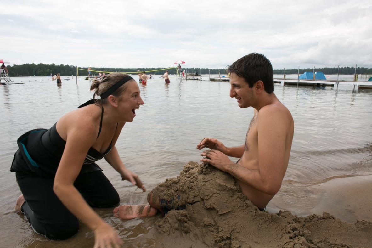 Playing in the sand on the shoreline.