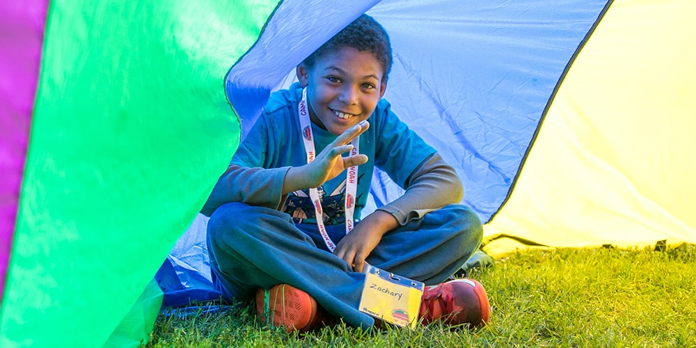 Young boy smiling and waving