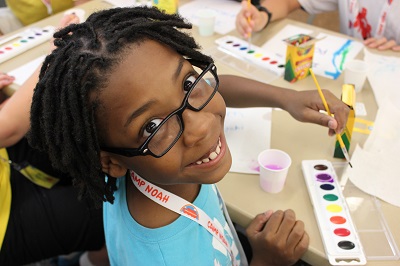 girl painting at camp noah