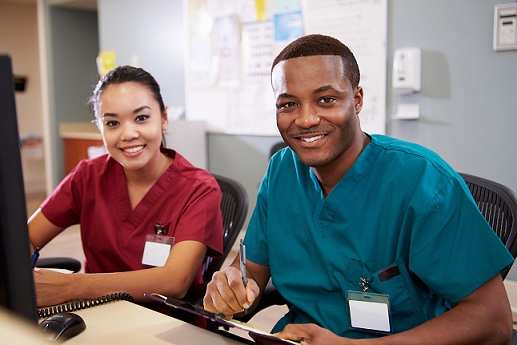 Two smiling healthcare professionals.