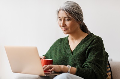 Middle-aged woman typing on laptop