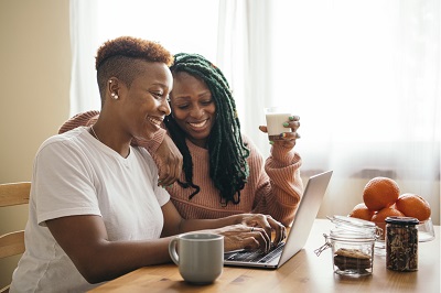 Two adult women on computer