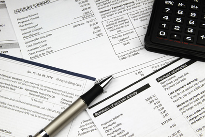 Calculator, financial statements, and pen