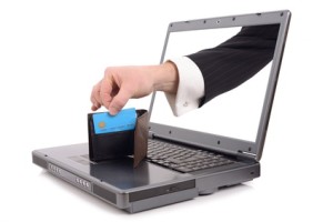 Arm reaching out of computer screen stealing from wallet