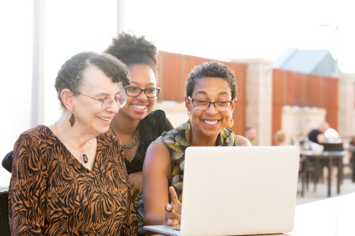 three generations of women together  at laptop