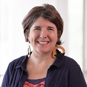 A person smiling at the camera

Description automatically generated