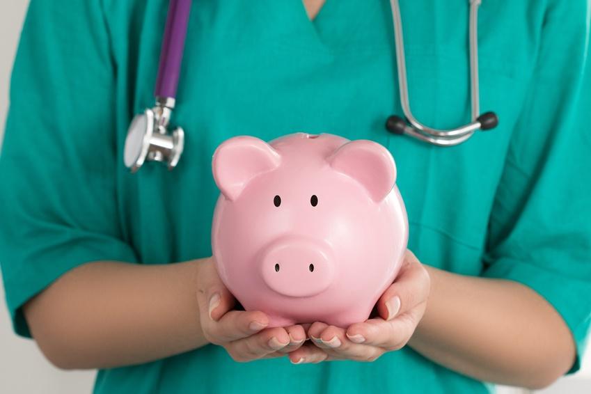 doctor holding a piggy bank