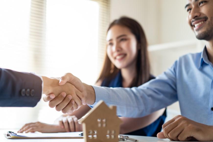 Men shaking hands after finalizing home purchase
