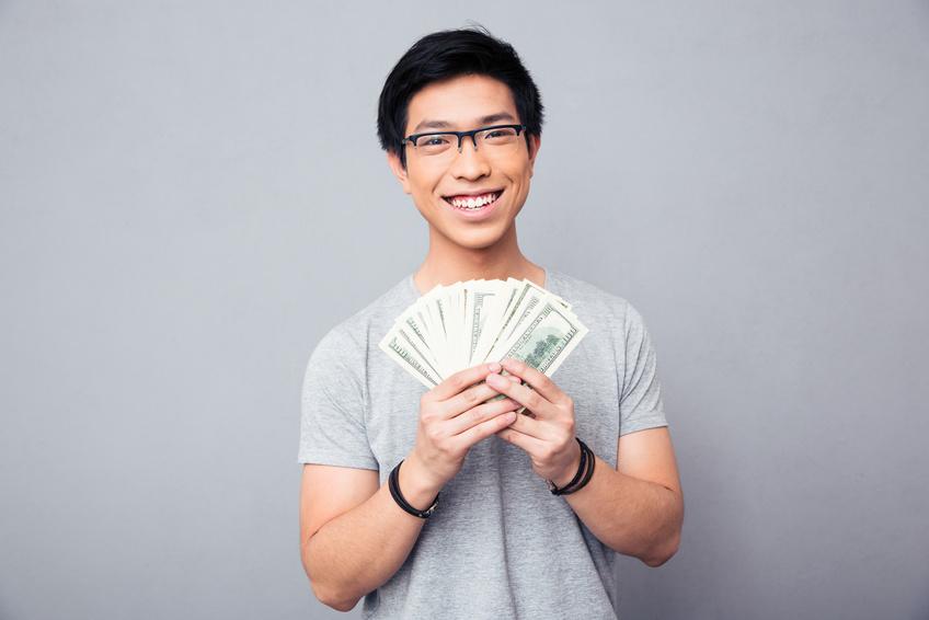 Man holding and displaying money