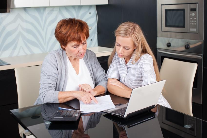 Mother and daughter looking over statement