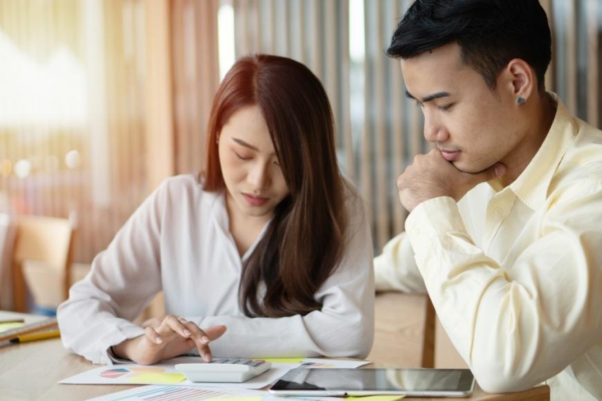 Couple using calculator