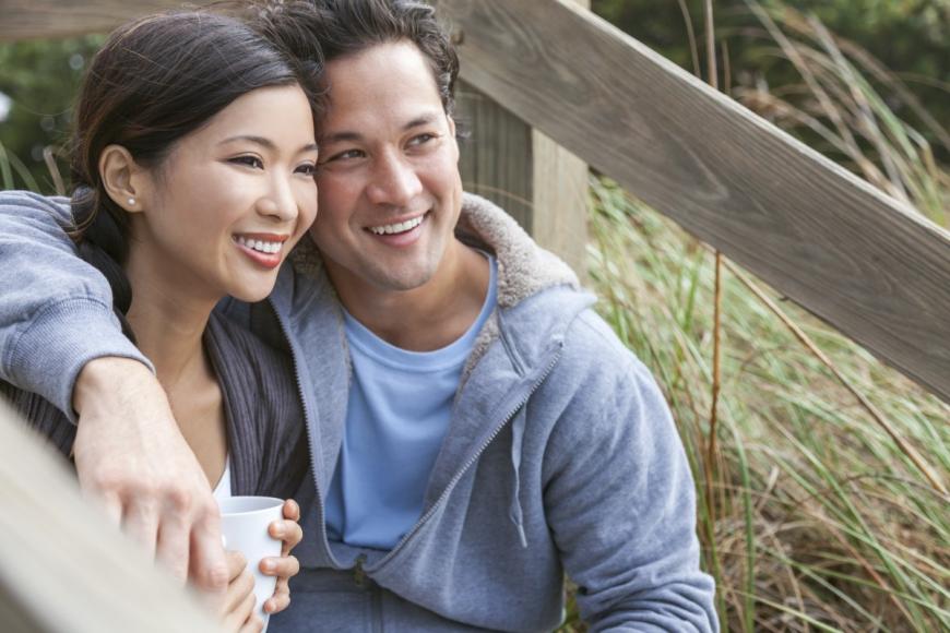 Couple smiling with arms around each other