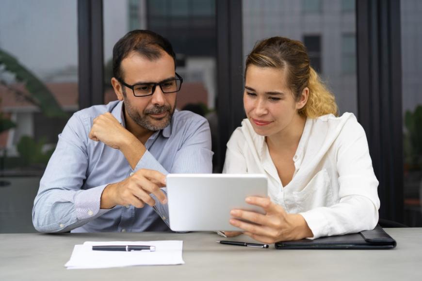 Man and woman looking at tablet
