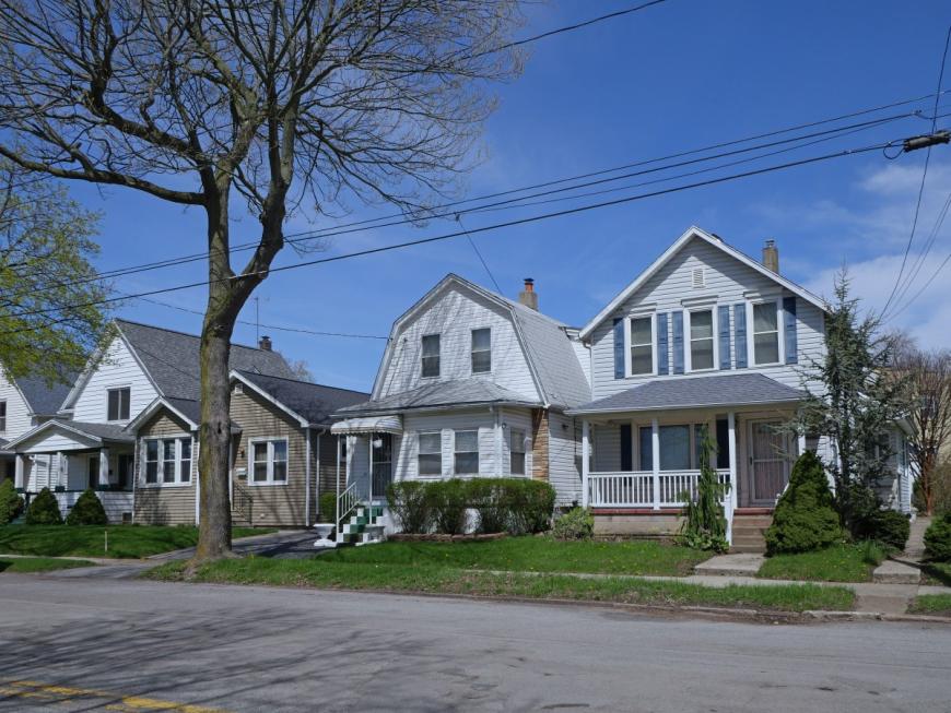 Outside of three houses standing next to each other on residential street