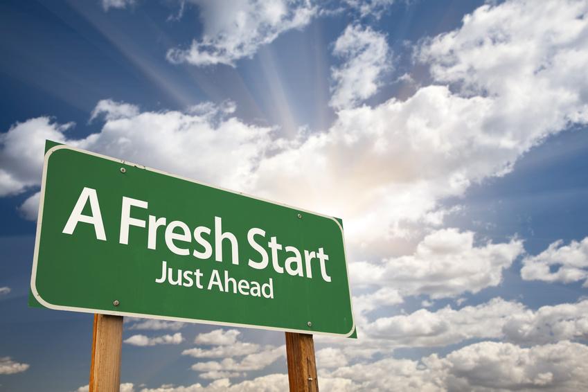 Green road sign with words A Fresh Start Just Ahead painted in white