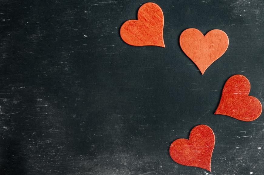 Four red heart shapes on black background