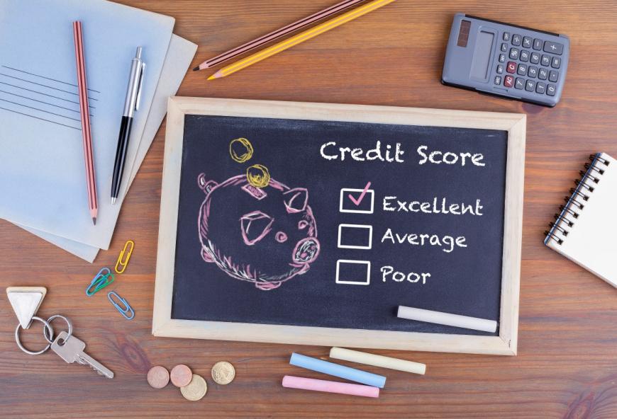 Small chalkboard with words, Credit Score, Excellent, Average, Poor and the box next to Excellent checked