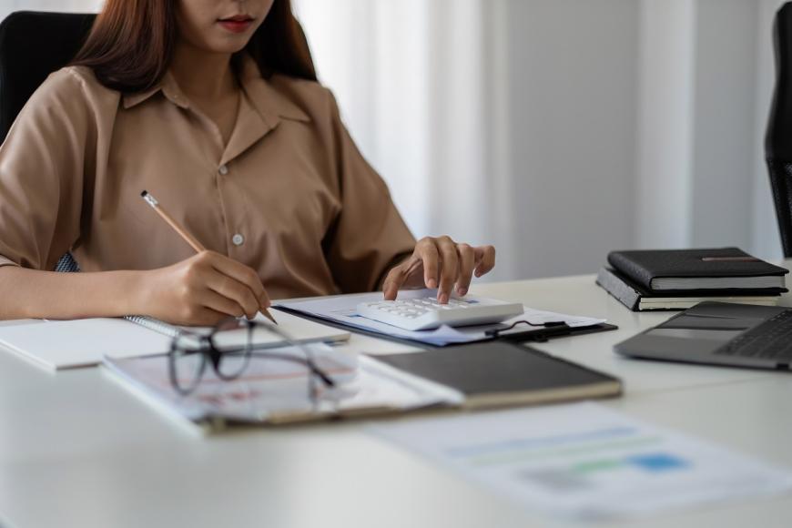 woman sitting at desk doing taxes