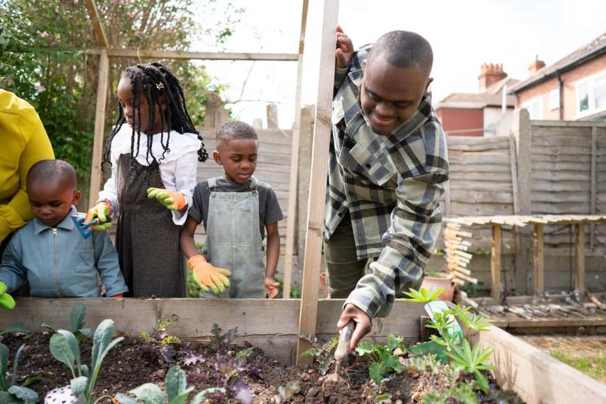 Man gardening with children