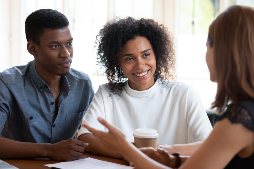 african american couple talking with financial counselor