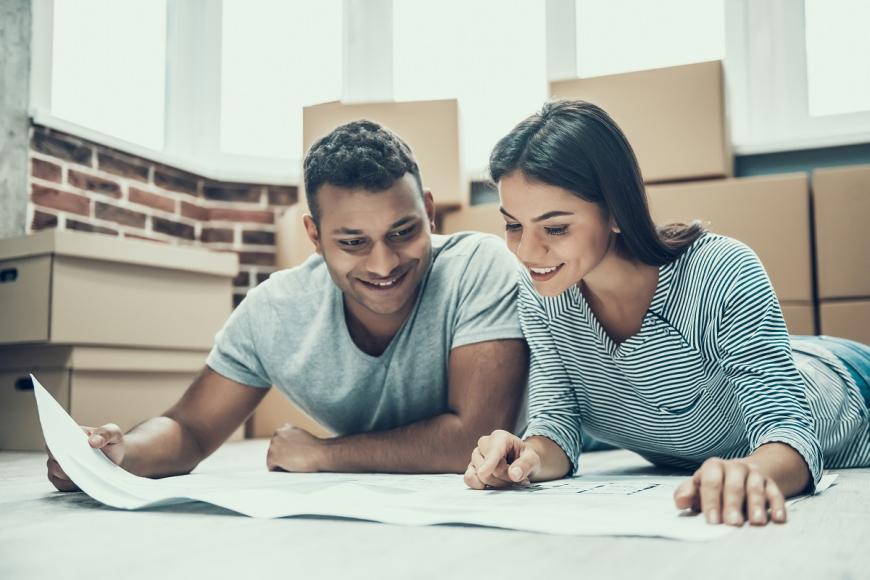 Indian couple looking at blueprints