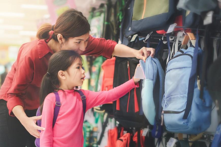 Mom and daughter buying backpack