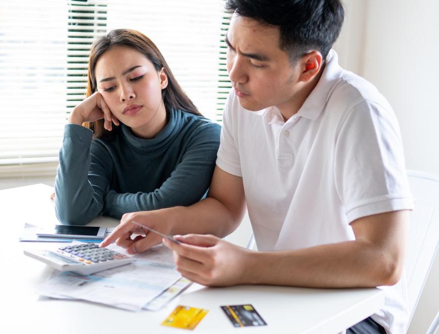 couple with credit cards and calculator