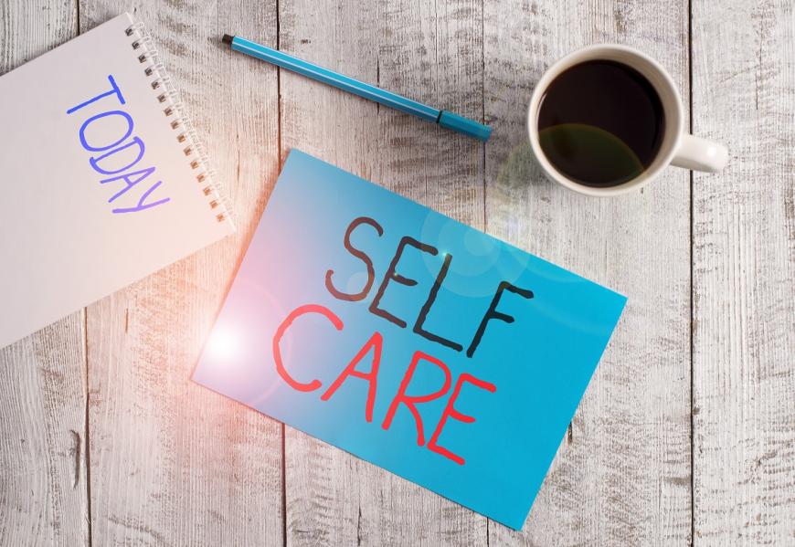 Self care written on blue post it