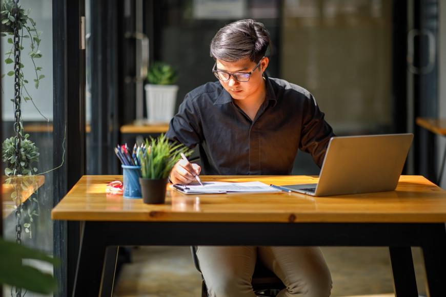 Asian man on laptop