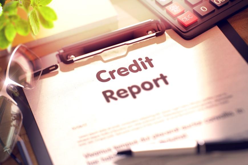 credit report and pen on clipboard