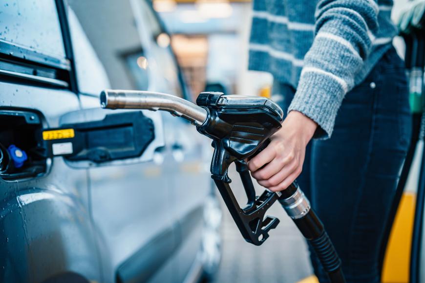 Woman pumping gas into her auto