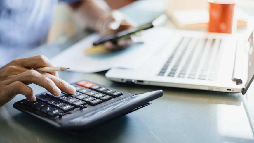 person typing on calculator