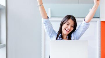 Woman celebrating at her computer