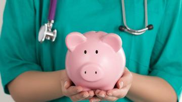 doctor holding a piggy bank