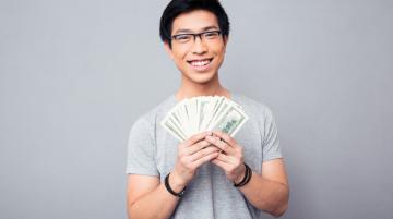 Man holding and displaying money