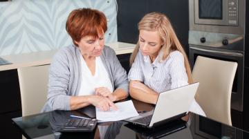 Mother and daughter looking over statement
