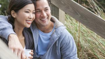 Couple smiling with arms around each other