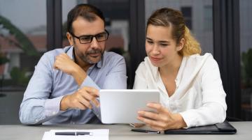 Man and woman looking at tablet