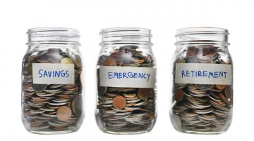 Three jars filled with coins. First labled Savings, Second labeled Emergency, Third labled Retirement