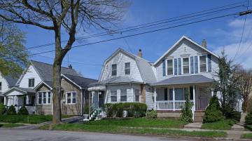 Outside of three houses standing next to each other on residential street
