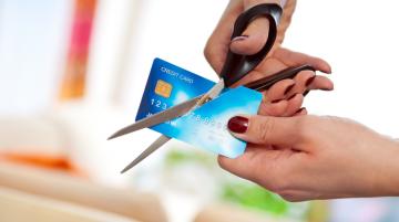 Person cutting up credit card