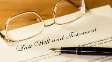 Eye glasses and pen on top of document that is titled, "Last Will and Testament"