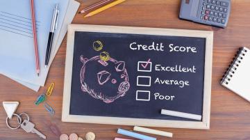 Small chalkboard with words, Credit Score, Excellent, Average, Poor and the box next to Excellent checked