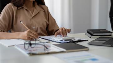 woman sitting at desk doing taxes