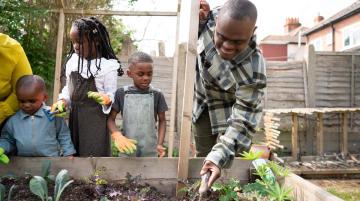 Man gardening with children