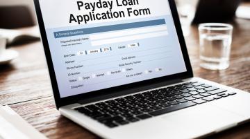 Laptop with the words Paycheck Loan Application Form on the screen