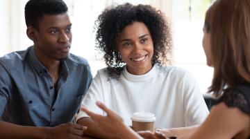 african american couple talking with financial counselor