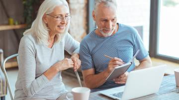 middle aged man and woman on laptop