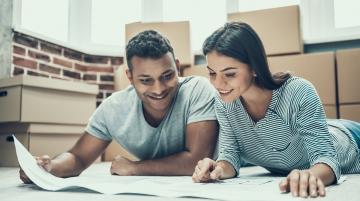 Indian couple looking at blueprints